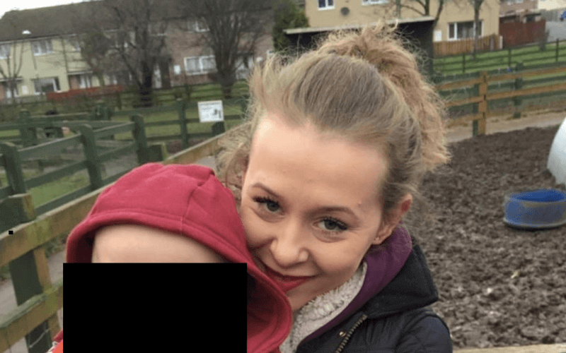 Philippa Day holding her young son (whose face is obscured)